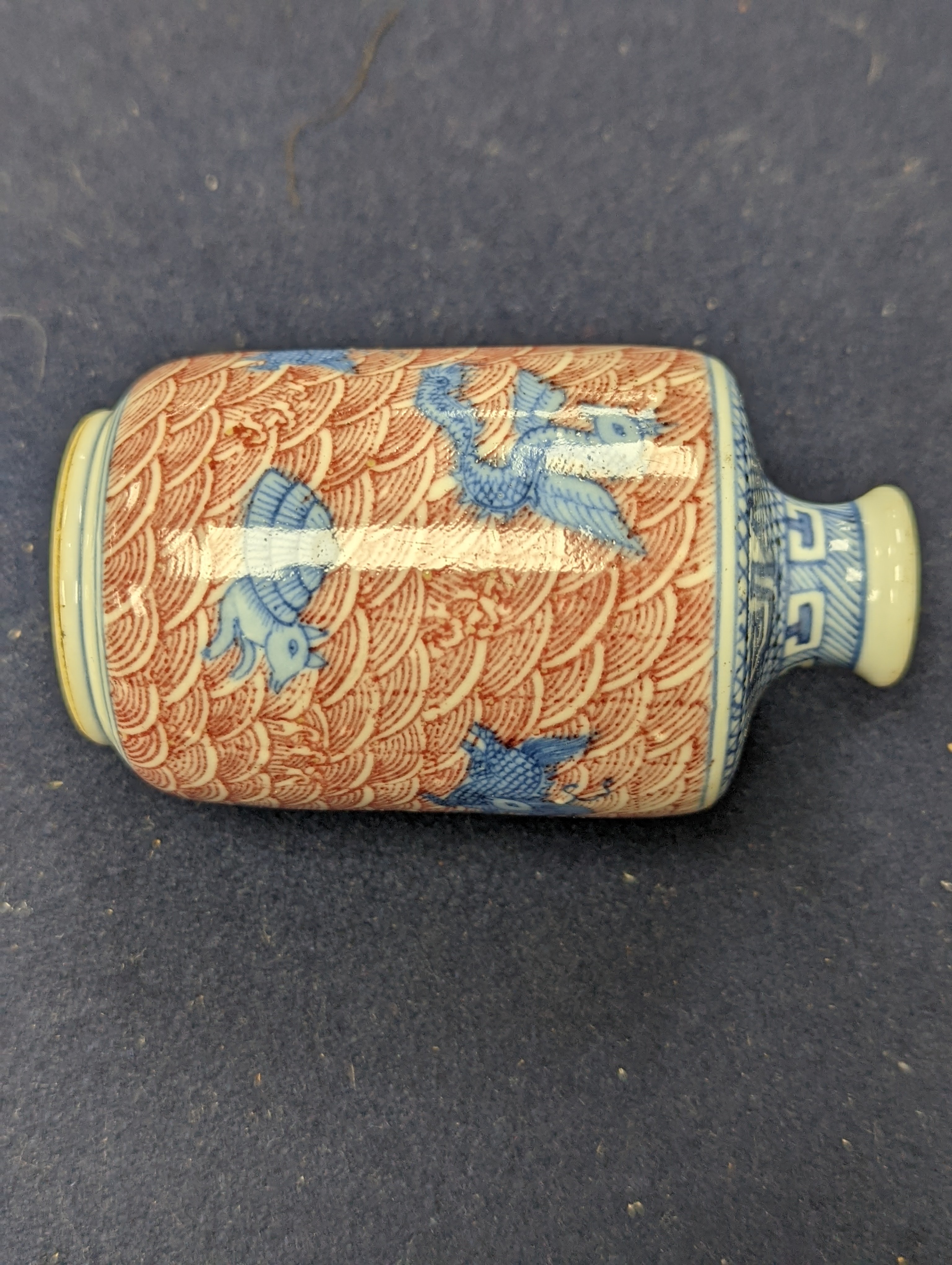 Three Chinese underglaze blue and copper red snuff bottles, 9cm